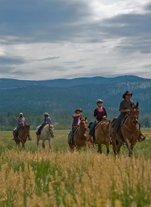 9421 couple horseback riding sunset